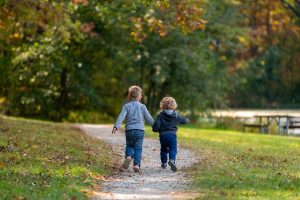 two children running in a park