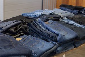 jeans at a thrift shop folded on a table