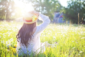 a girl sitting in a field