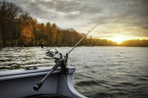 a fishing rod leaning against a boat on a lake