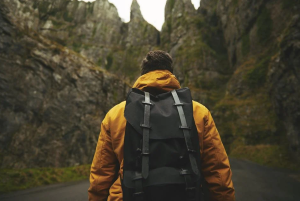 a man in a yellow jacket on a hike